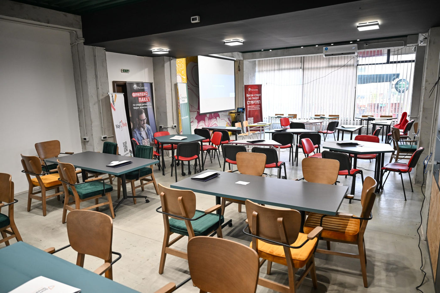 The Srekja event room set up with tables and chairs before an event