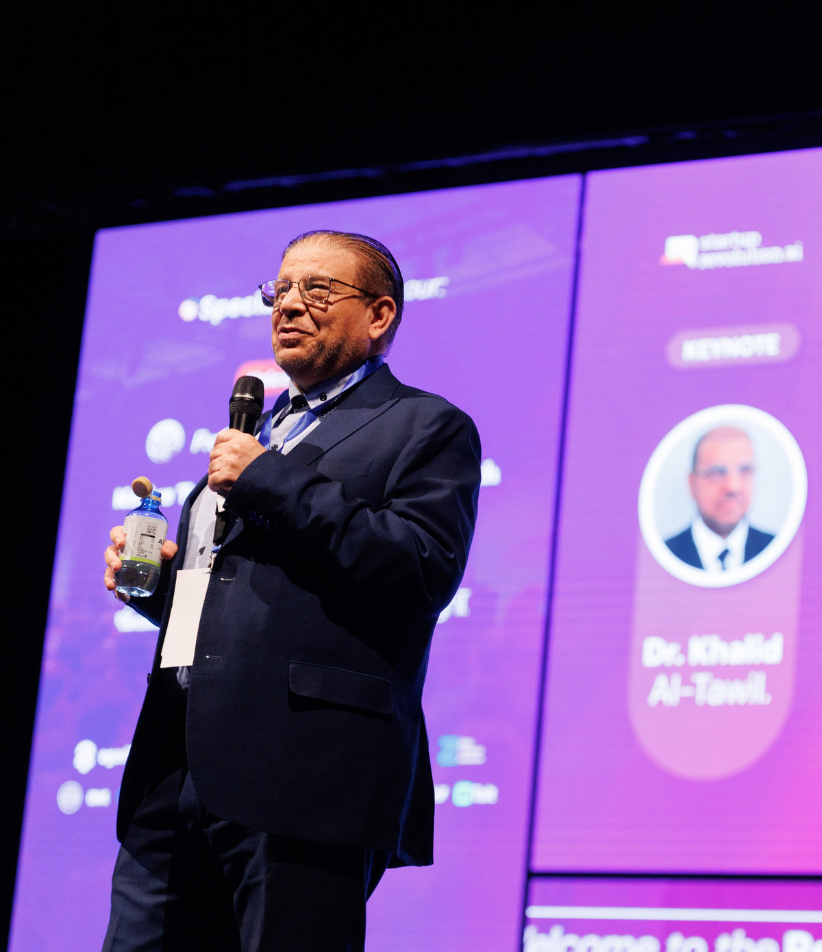 A senior investor in conversation at the summit floor.