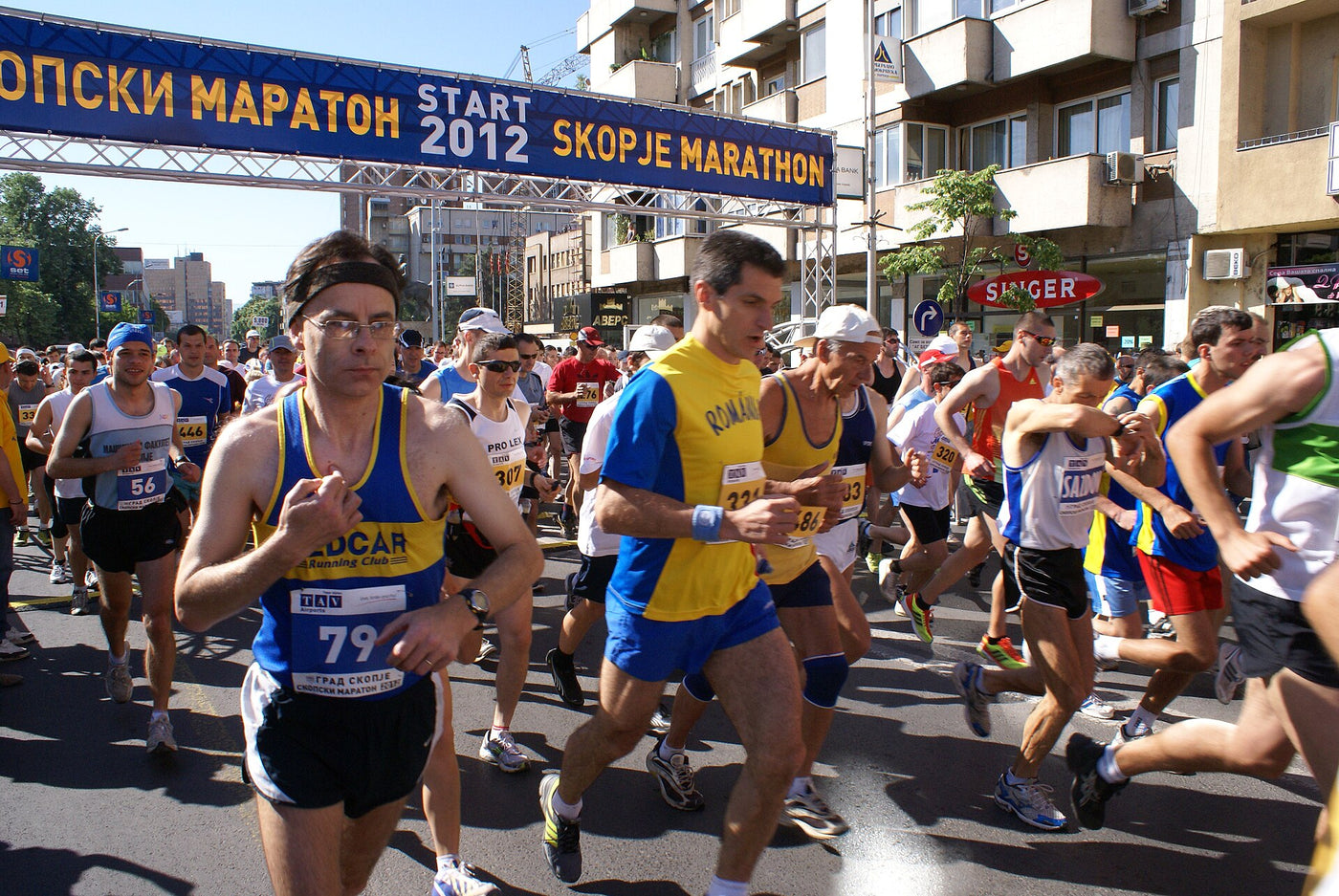 Runners crossing the start line of the Skopje Marathon in the city centre